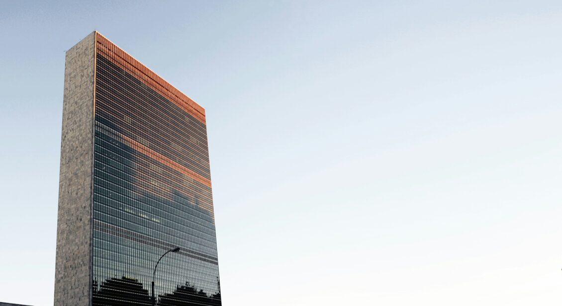 Image of the United Nations Headquarters in New York against a blue sky.